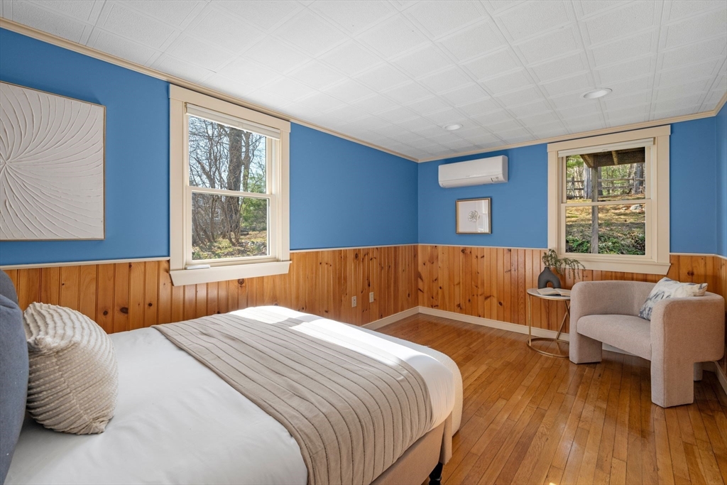 154 R Eastern Avenue Essex, MA 01929 - Photo 16 of 40 a bedroom with a large bed and a large window