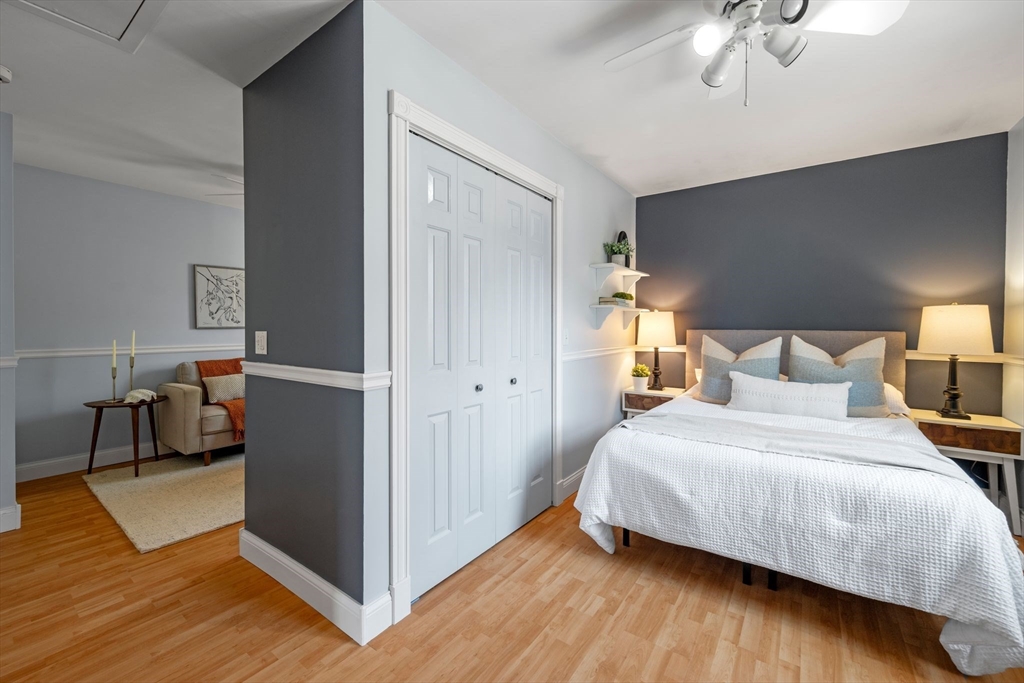 154 R Eastern Avenue Essex, MA 01929 - Photo 20 of 40 a bedroom with a bed and a chandelier