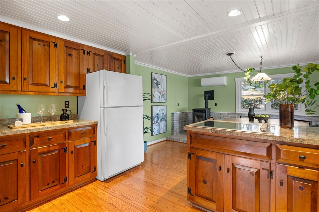 154 R Eastern Avenue Essex, MA 01929 - Photo 9 of 40 a kitchen with stainless steel appliances granite countertop a refrigerator a sink dishwasher and white cabinets with wooden floor