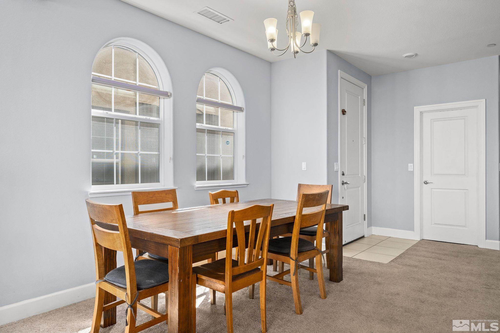 1995 Wind Ranch Road, Unit C Reno, NV 89521 - Photo 8 of 20 a view of a dining room with furniture and chandelier