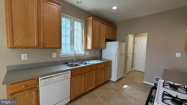 a kitchen with a sink cabinets and appliances