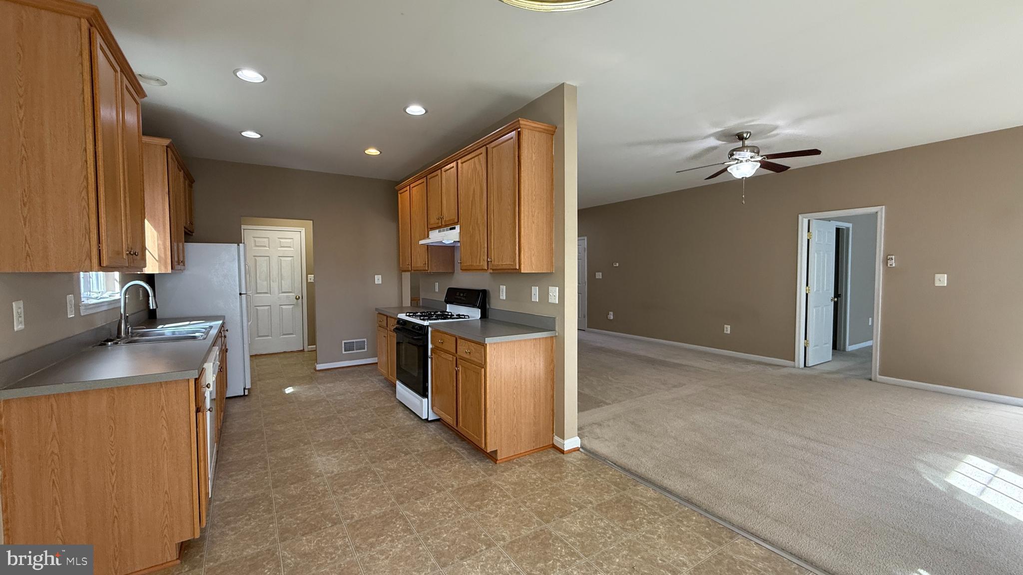 35484 Somerset Ridge Road Locust Grove, VA 22508 - Photo 5 of 22 a kitchen with kitchen island granite countertop a sink a counter top space appliances and cabinets