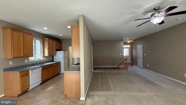 a view of a kitchen with a sink and cabinets