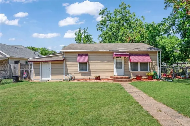 a front view of house with yard and green space