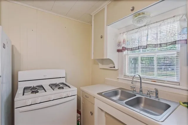a view of washer and dryer with bathroom in the background