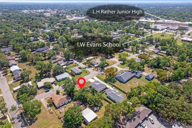 an aerial view of residential houses with outdoor space and parking