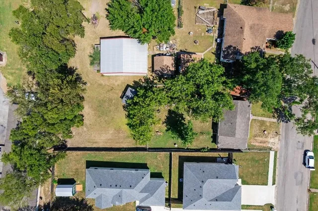 an aerial view of a house with a yard and garden
