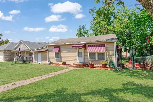 a front view of house with yard and outdoor seating