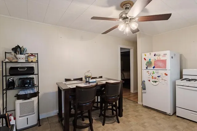 a view of a dining room with furniture and chandelier