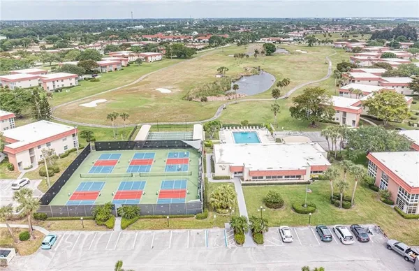 an aerial view of residential houses with outdoor space and swimming pool