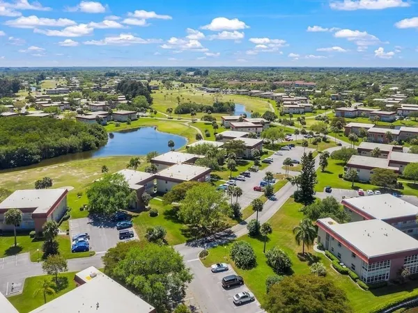 an aerial view of residential houses with outdoor space and river