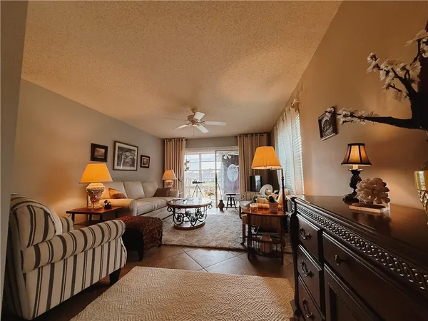 a living room with furniture fireplace and a window