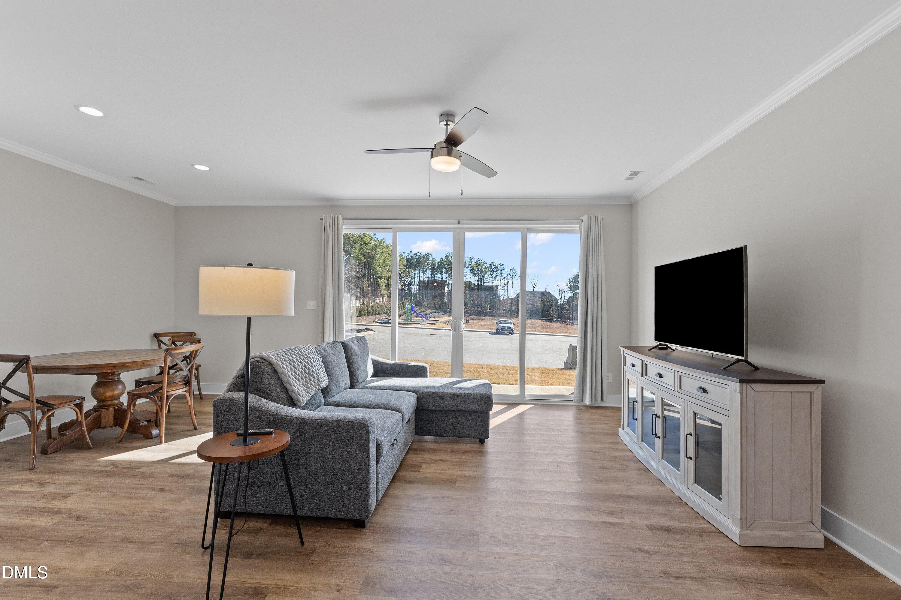 718 Jamescroft Way Rolesville, NC 27571 - Photo 16 of 40 a living room with furniture and a flat screen tv