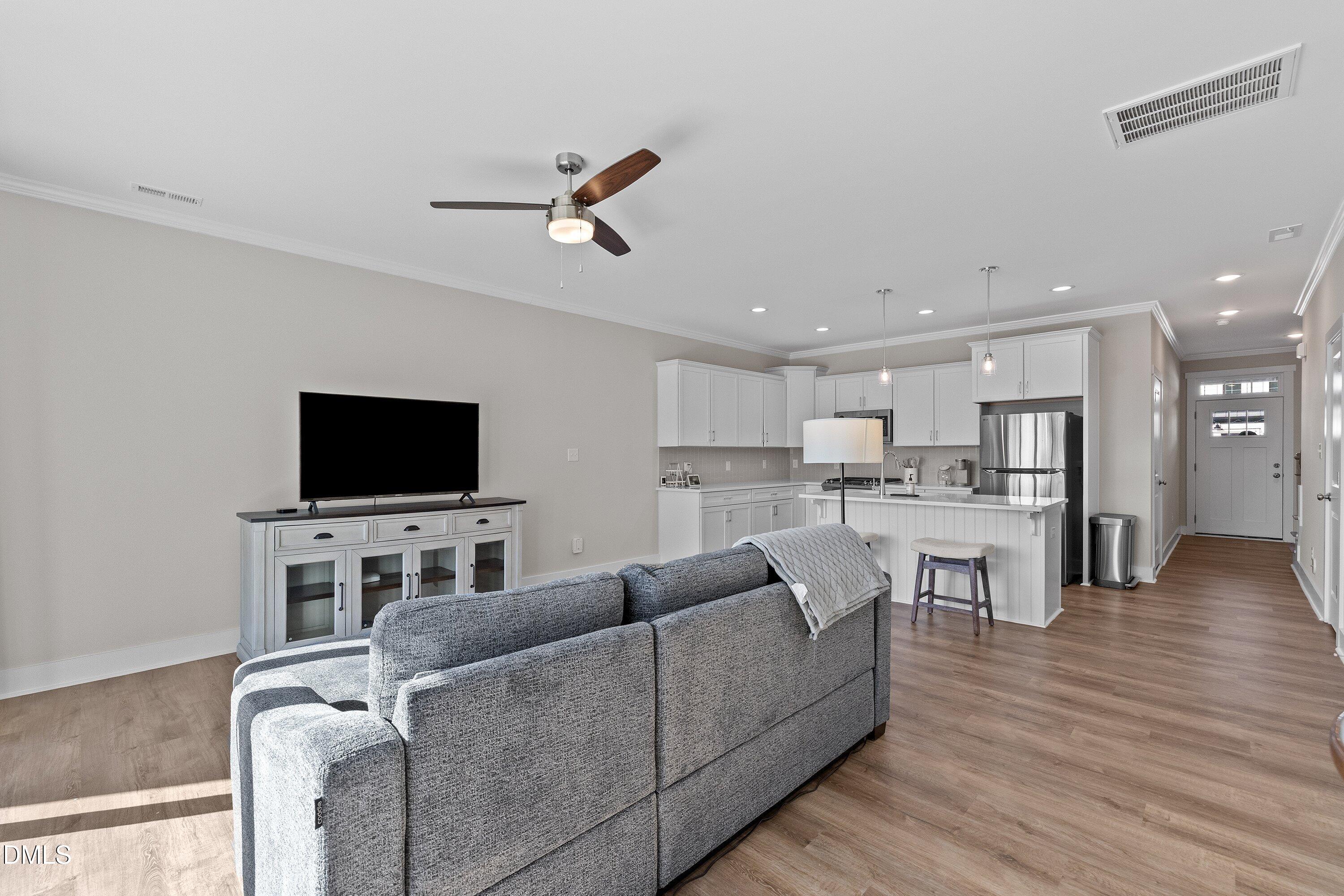718 Jamescroft Way Rolesville, NC 27571 - Photo 18 of 40 a living room with furniture and a flat screen tv