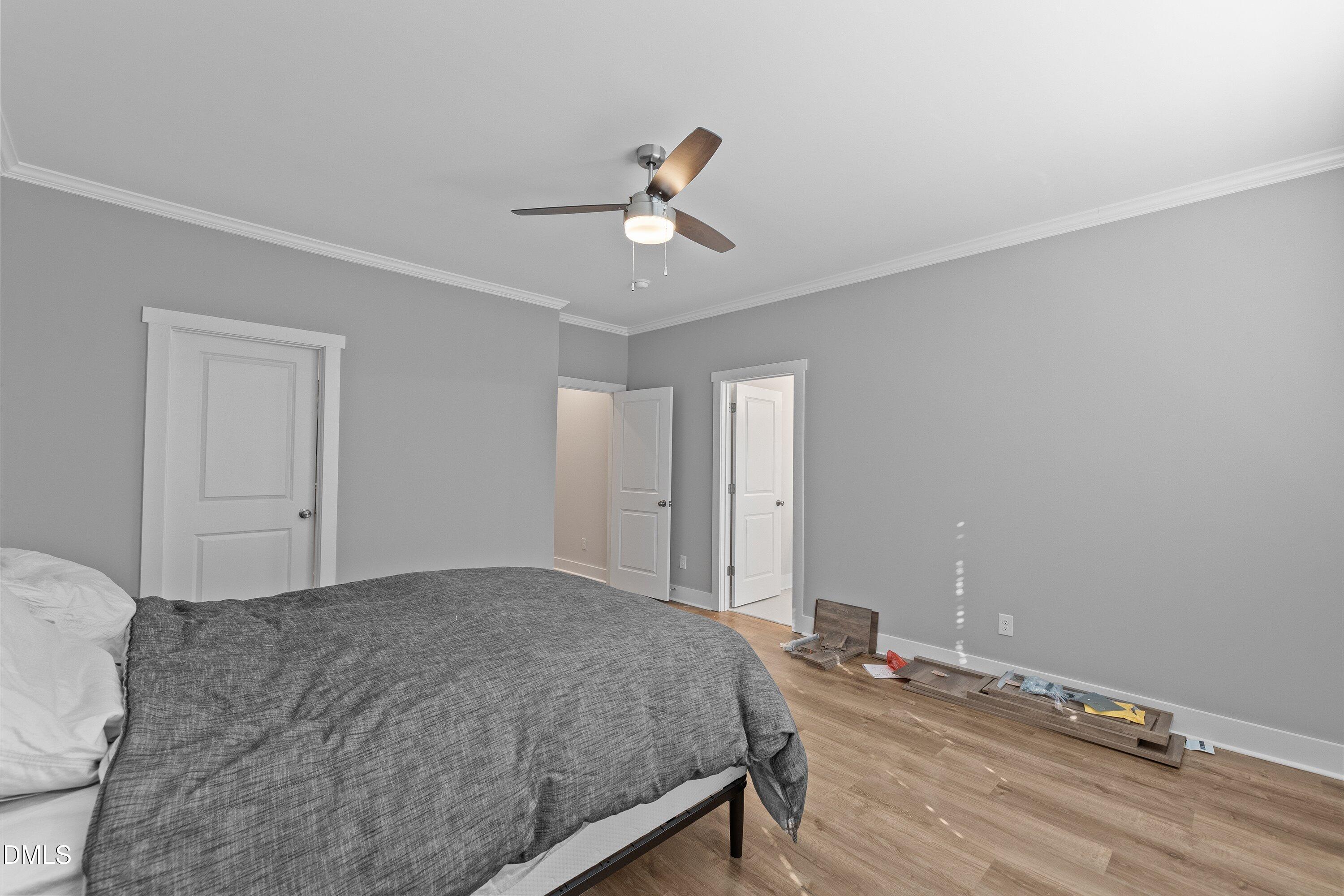 718 Jamescroft Way Rolesville, NC 27571 - Photo 26 of 40 a bedroom with a bed and a chandelier fan