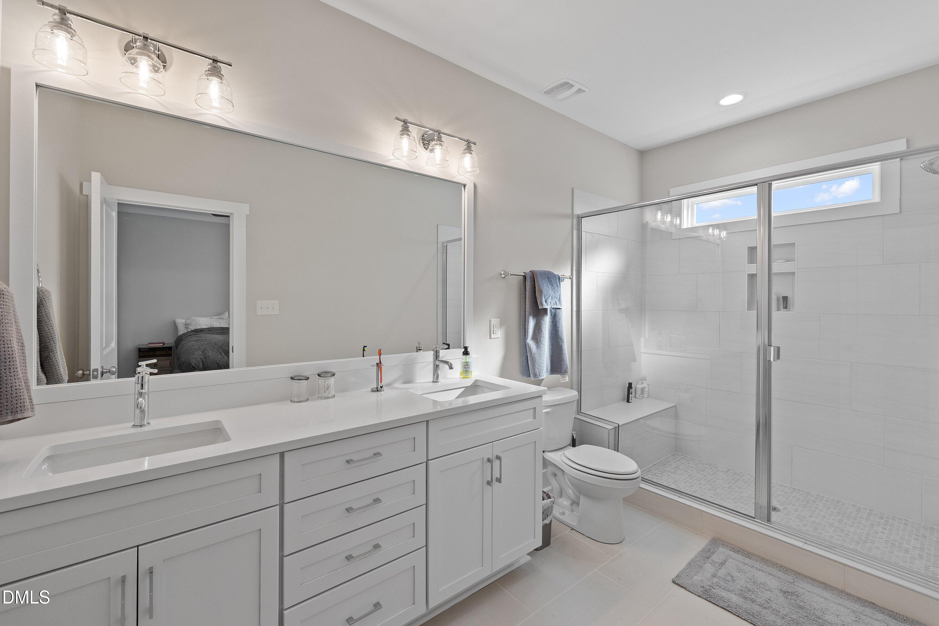 718 Jamescroft Way Rolesville, NC 27571 - Photo 27 of 40 a spacious bathroom with double sink a toilet a shower and a mirror