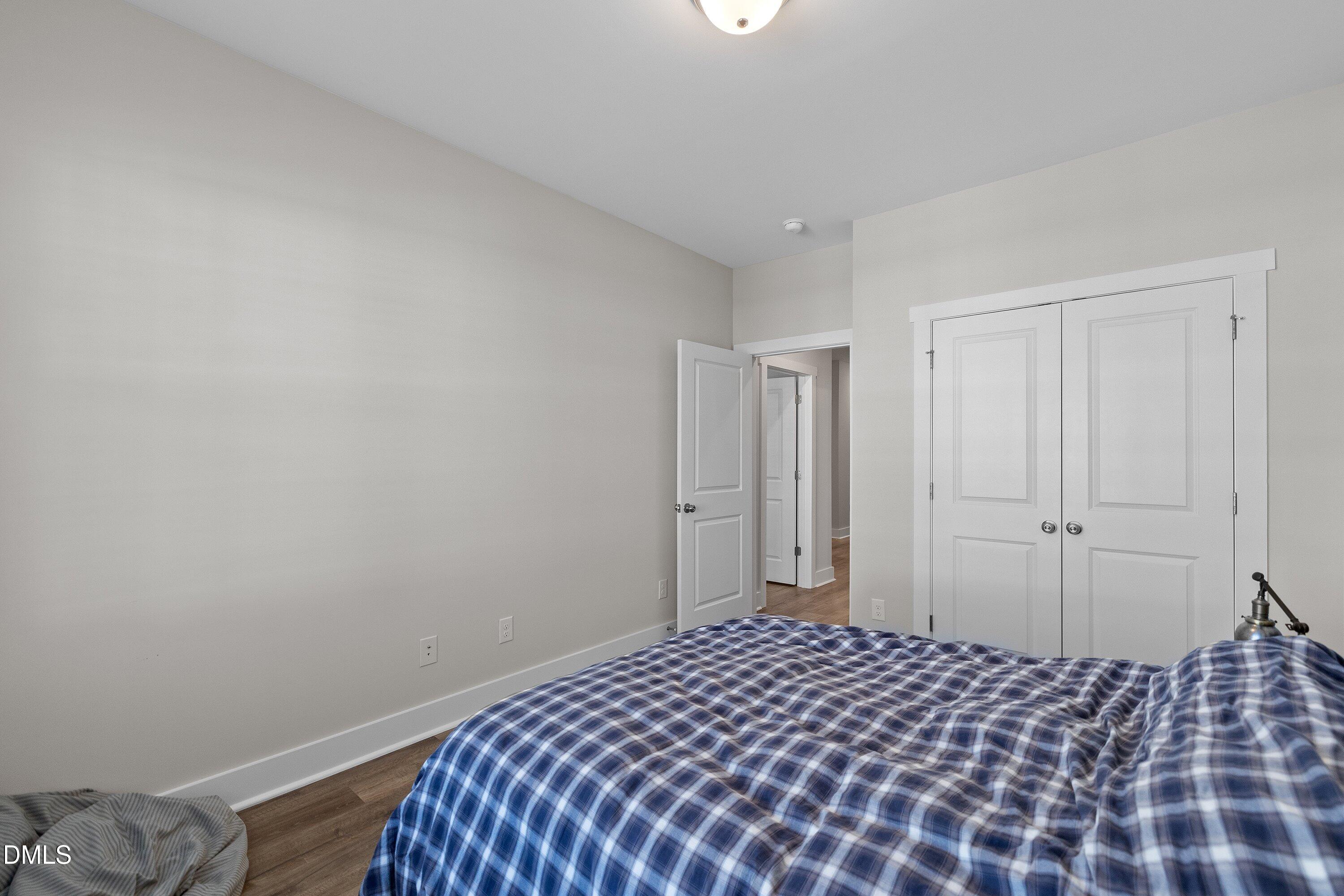 718 Jamescroft Way Rolesville, NC 27571 - Photo 30 of 40 a bedroom with a bed and a lamp