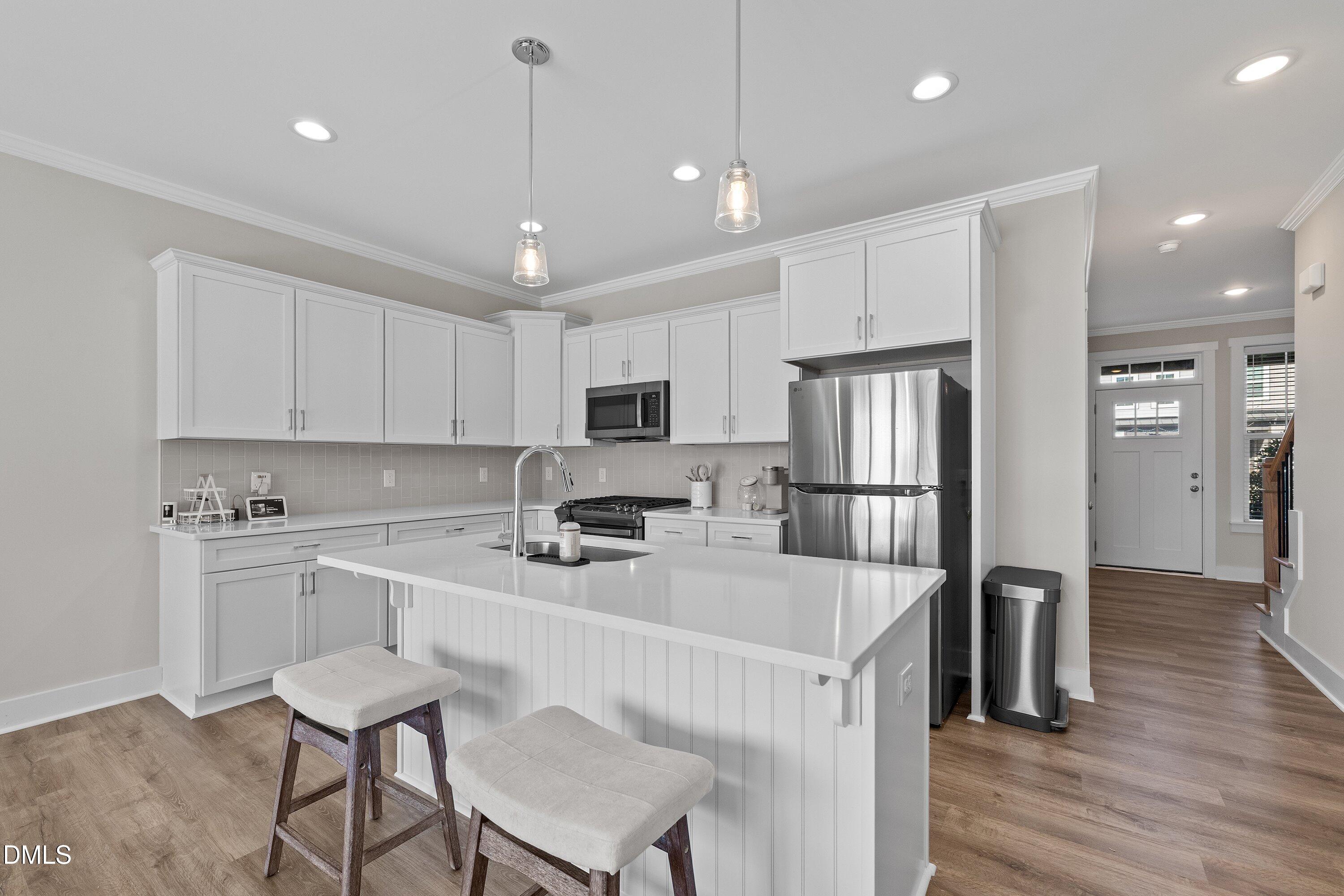718 Jamescroft Way Rolesville, NC 27571 - Photo 9 of 40 a kitchen that has a lot of cabinets a sink and appliances in it