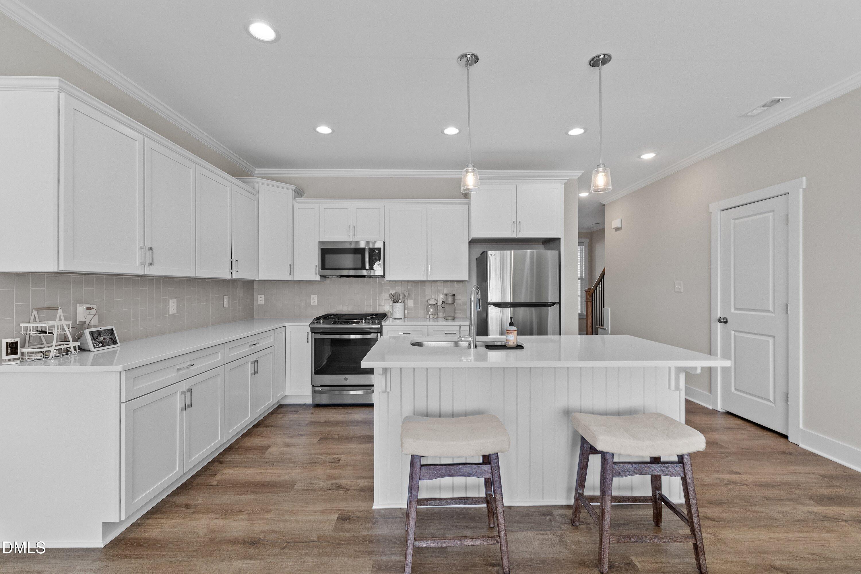 718 Jamescroft Way Rolesville, NC 27571 - Photo 10 of 40 a large white kitchen with lots of counter space a sink appliances and cabinets