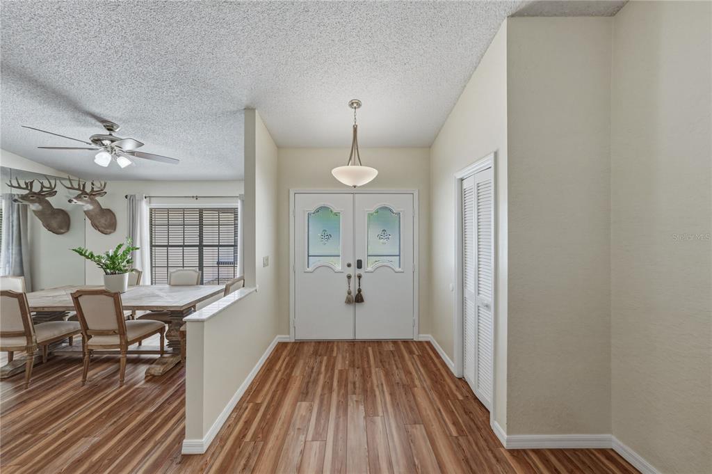 7435 Kilbride Court Weeki Wachee, FL 34613 - Photo 4 of 67 a view of a room with wooden floor table and chairs