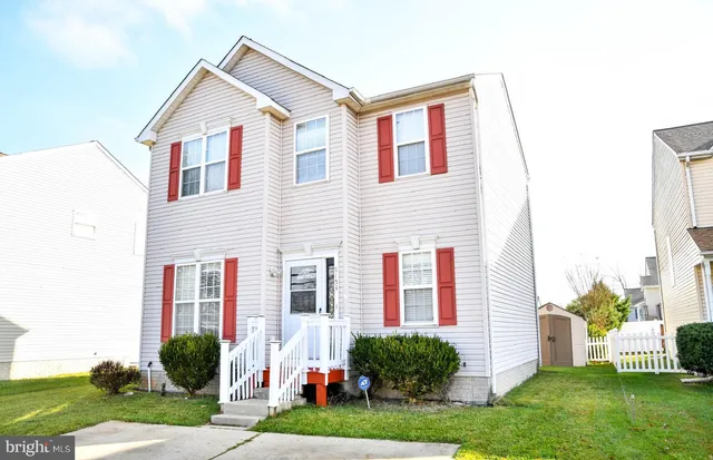 a front view of a house with a yard and plants