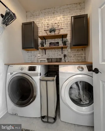 a utility room with sink washer and dryer