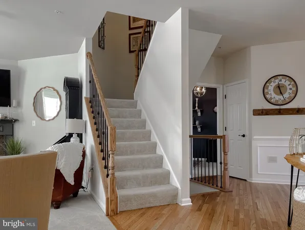 a view of a hallway with entryway wooden floor and front door