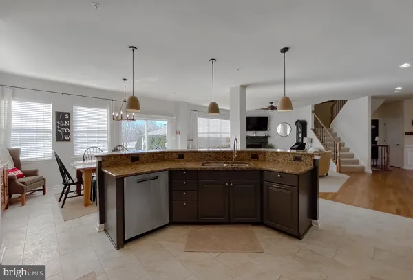 a view of kitchen with stainless steel appliances granite countertop sink stove and wooden floor