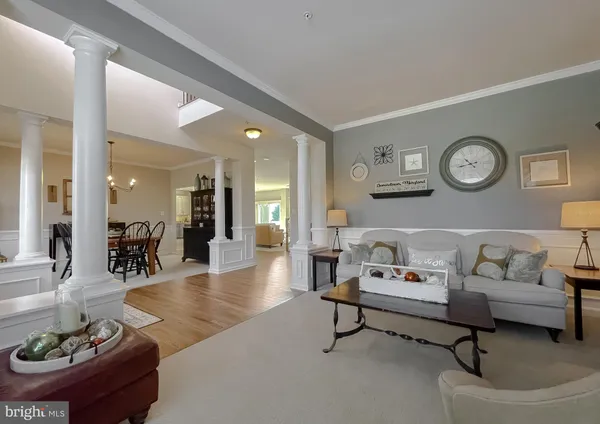 a living room with furniture and clock on the wall