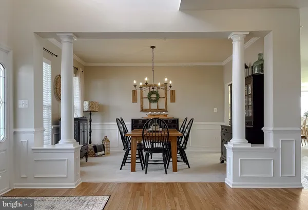 a view of a dining room with furniture and wooden floor