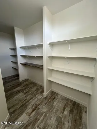 a view of walk in closet with empty racks