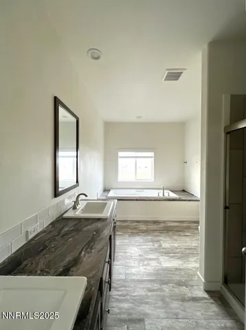 a bathroom with a granite countertop sink and a mirror