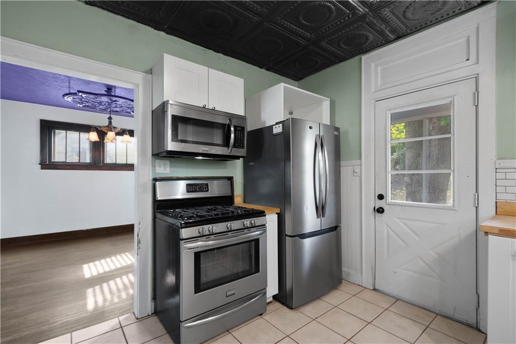 808 5th Avenue Coraopolis, PA 15108 - Photo 13 of 30 a kitchen with granite countertop a stainless steel appliances a refrigerator and a stove top oven