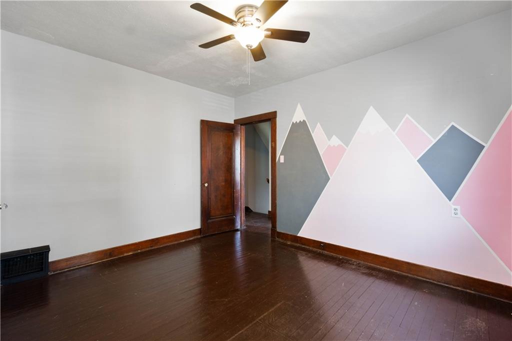 808 5th Avenue Coraopolis, PA 15108 - Photo 19 of 30 a view of an empty room with wooden floor and a ceiling fan