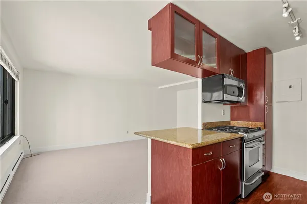 a kitchen with a sink stove and cabinets