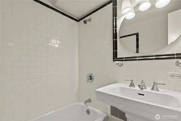 a bathroom with a sink a mirror and a bathtub