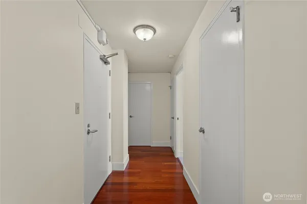 a view of a hallway with wooden floor