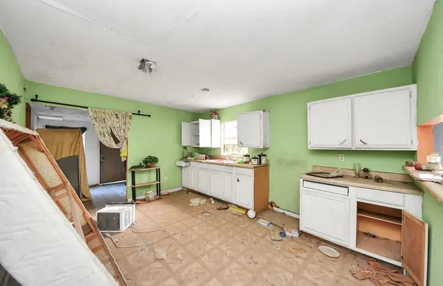 a kitchen with a stove a refrigerator and cabinets