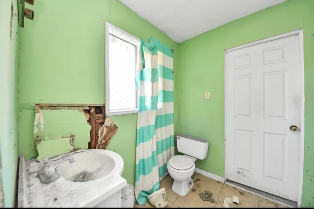 a bathroom with a toilet and a sink