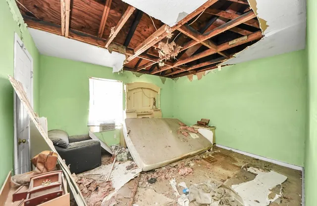 a bedroom with a bed and a window