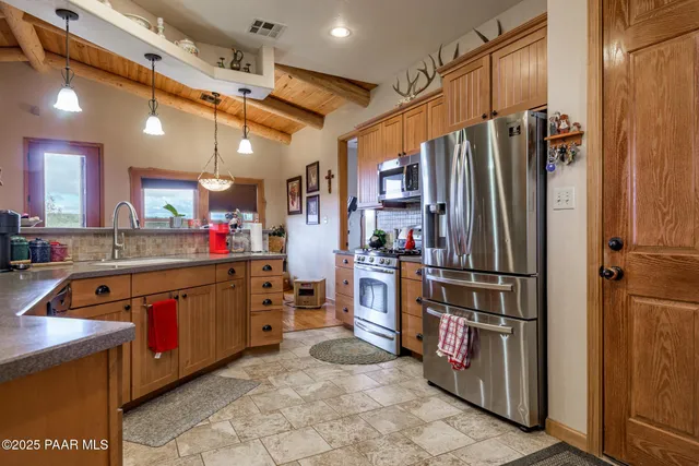 a kitchen with stainless steel appliances granite countertop a stove and a microwave