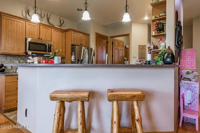 a dining room with furniture a chandelier and wooden floor