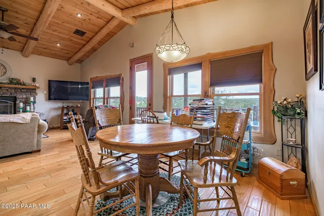 a bedroom with a bed a mirror on dresser and a chandelier