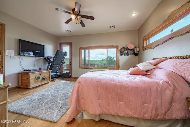 a bed room with a bed mirror and a desk