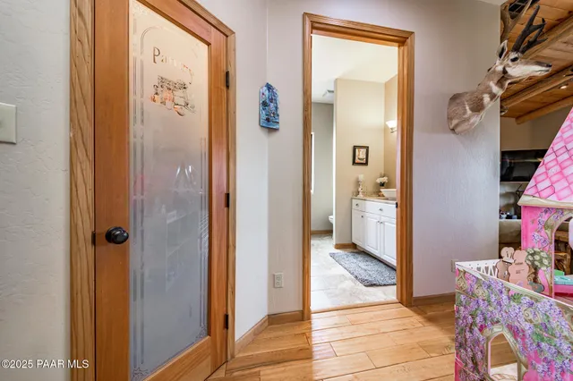 a bedroom with bed and wooden floor