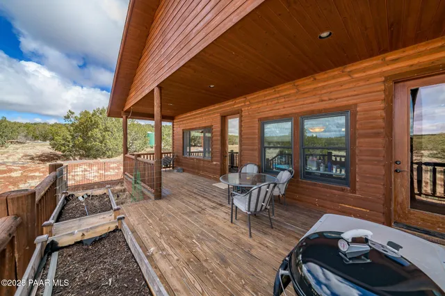 a view of a patio with chairs and table