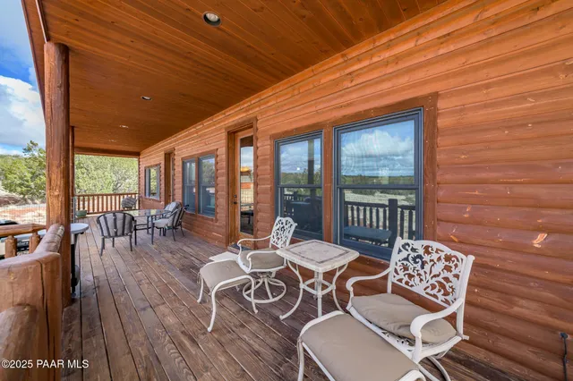 a view of a house with backyard porch and sitting area