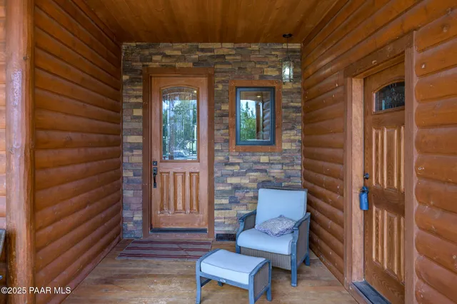 a view of a porch with furniture and wooden floor