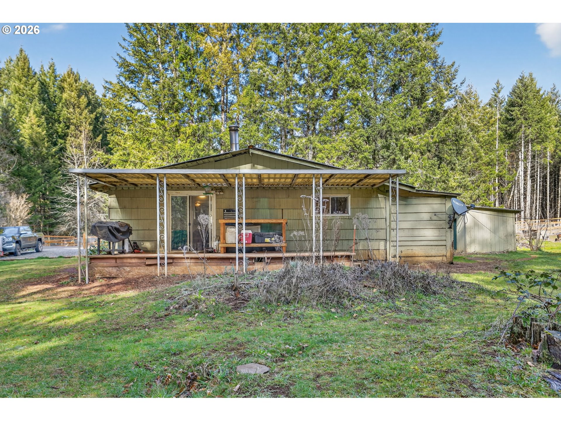 26200 Highway 211 Estacada, OR 97023 - Photo 14 of 24 a view of a house with a yard and sitting area