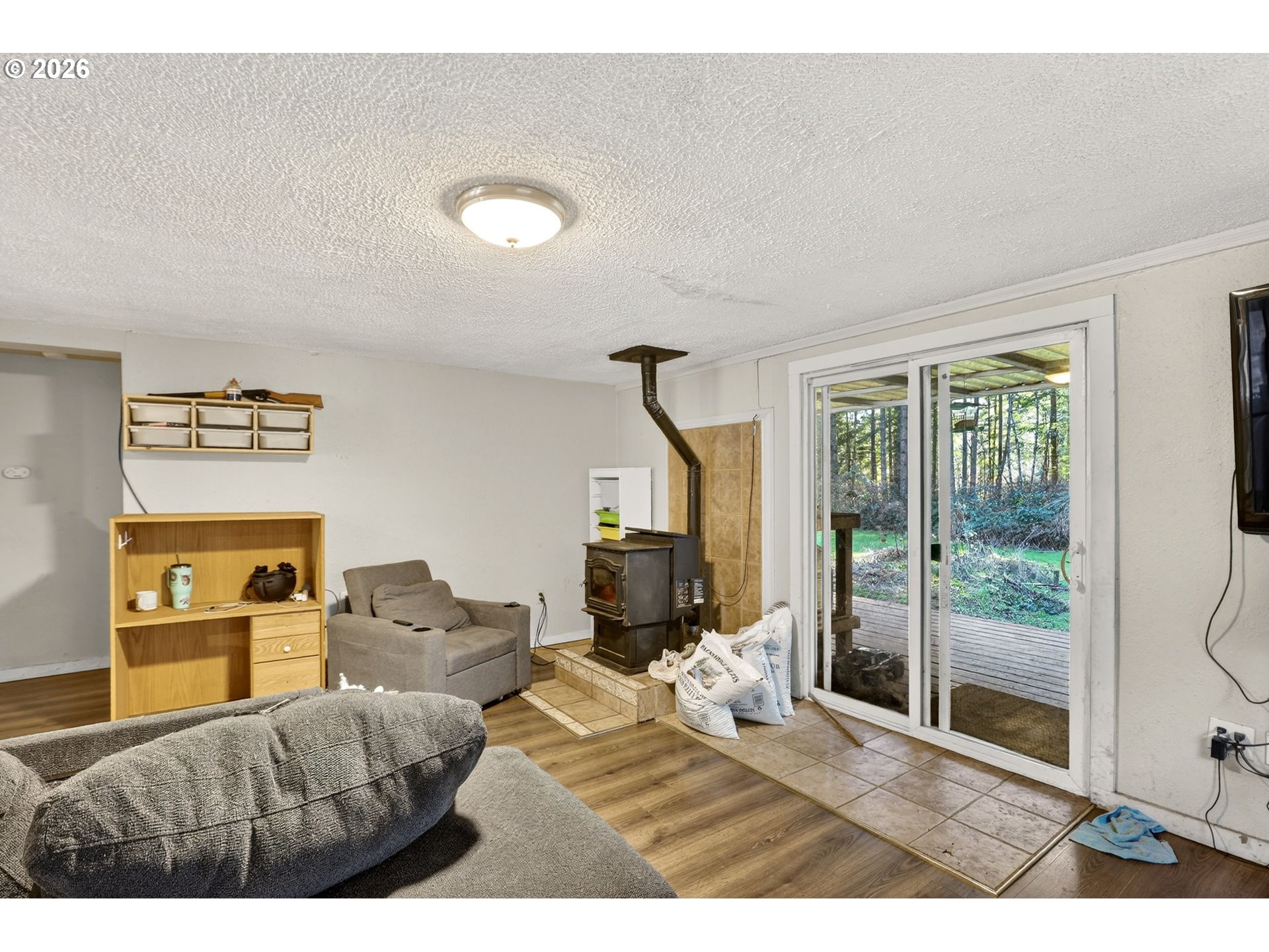 26200 Highway 211 Estacada, OR 97023 - Photo 5 of 24 a living room with furniture and a flat screen tv